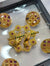 A gold-tone decorative brooch set with matching buttons, designed in a traditional ornamental style.